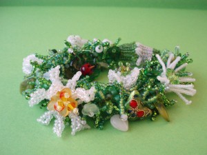 photo of Spring Garden fringe bracelet using green seed beads as leafy fringe and white seed beads of beaded flowers by Amanda Crago of Bowerbird Jewellery