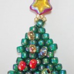 beaded green christmas tree with a red star bead on the top, made by Amanda Crago of Bowerbird Jewellery